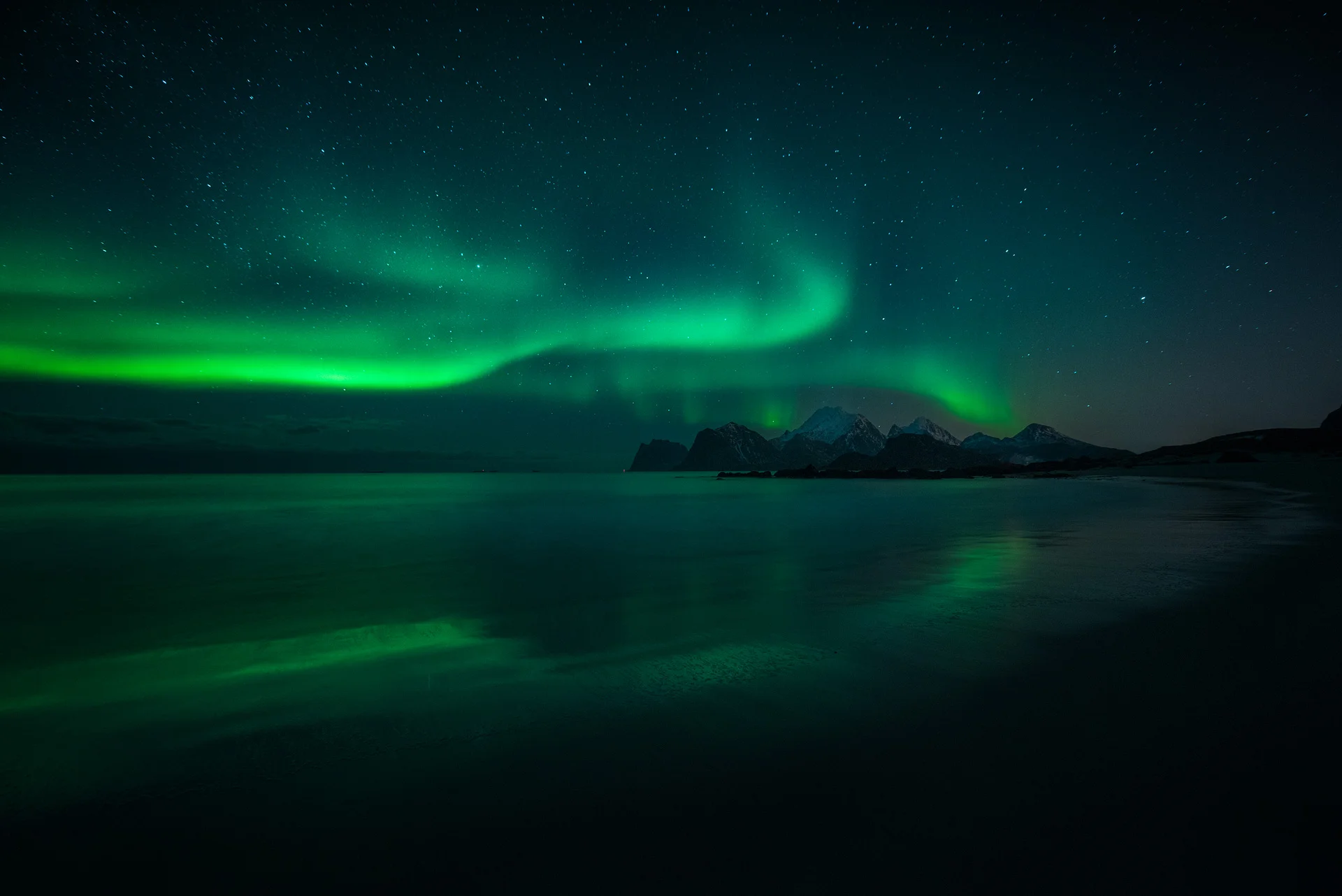 Emerald Ribbons Over Twilight Peaks